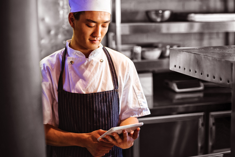 man in kitchen using display