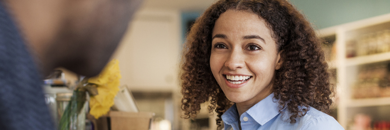 Happy customer interacting with retail worker