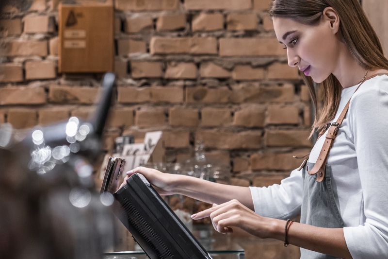 woman at pos at coffee shop