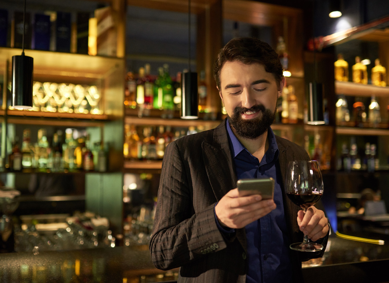 man on phone at bar