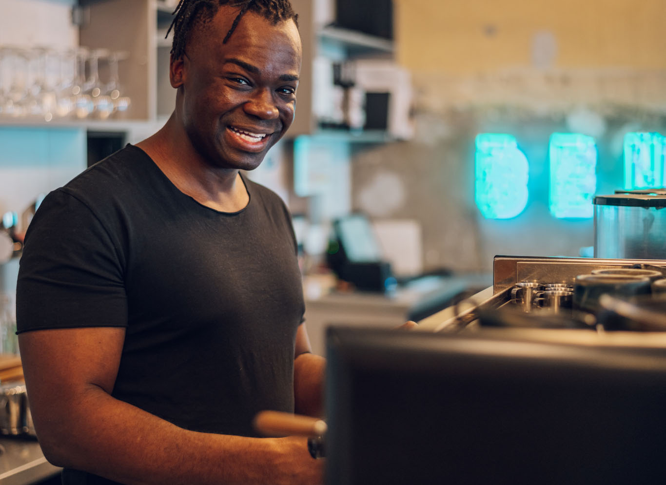 man smiling working in coffee shop