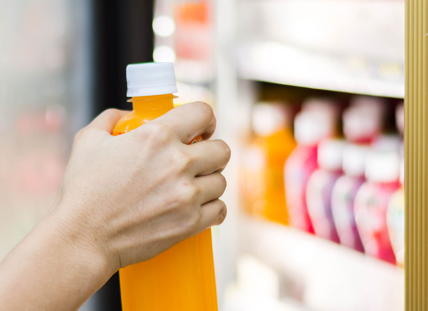 customer taking soda out of refrigerator