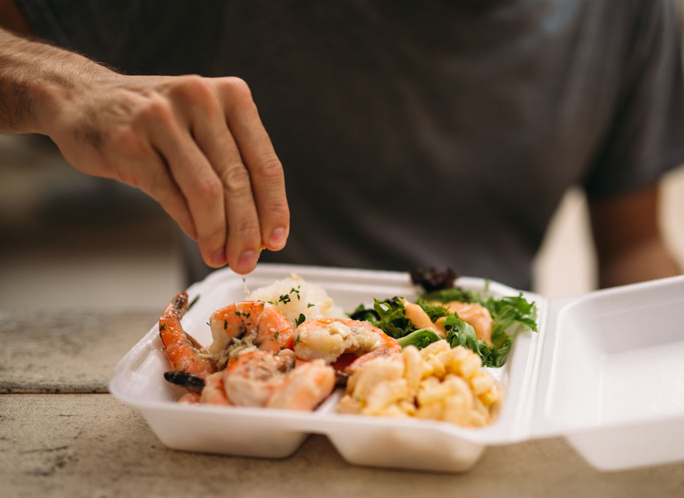 food truck customer putting lime on shrimp