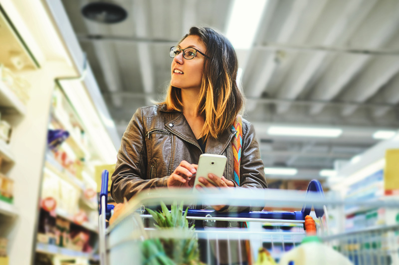 young woman shopping in modern grocery store